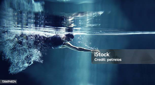 Athlete Swimming Freestyle On Blue Background Underwater View Stock Photo - Download Image Now