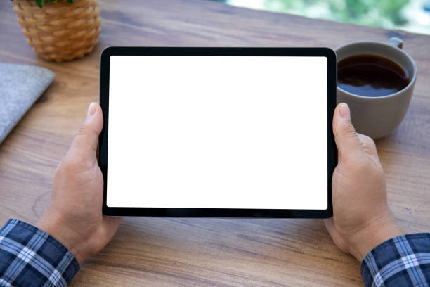 istock male hand holding computer tablet with isolated screen in office 1366948336