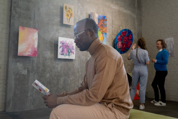 istock Man reading a brochure in art gallery 1366948690