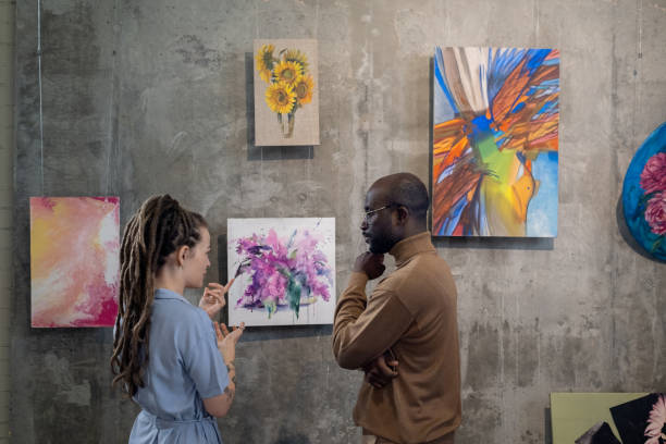 istock Couple discussing modern art in studio 1366948691