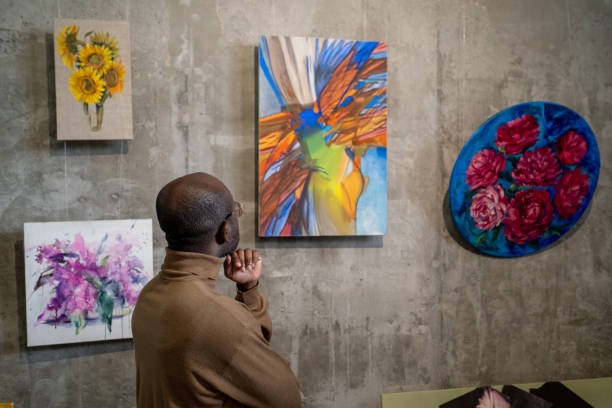 istock Man admiring paintings in studio 1366948712
