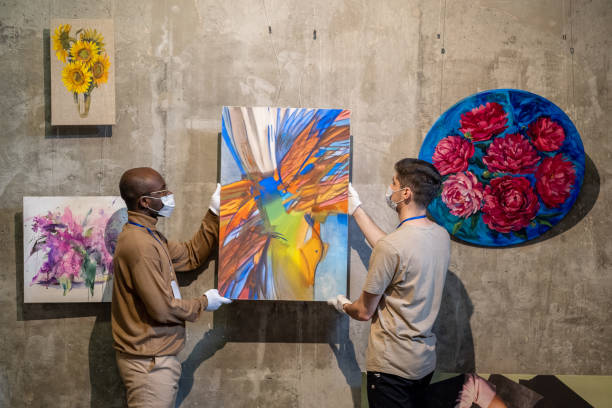 istock People hanging paintings for exhibition 1366948768