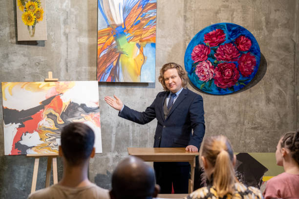 istock Painter presenting his paintings to the audience 1366948789