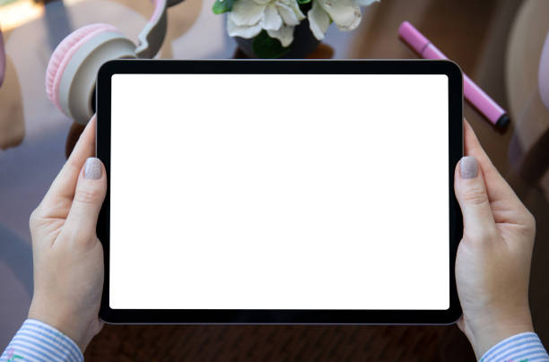 istock female hands holding computer tablet with isolated screen with headphones 1366948827