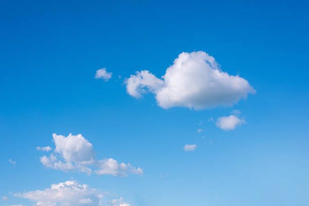 istock Beautiful fluffy clouds in a clear blue sky. 1366949673