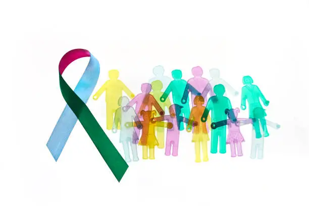 Photo of Rare Disease Day Background. Colorful awareness ribbon with group of people with rare diseases.