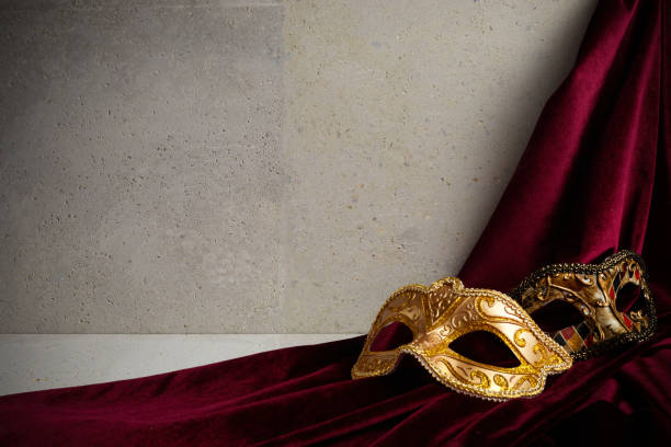 istock Venice carnival mask on travertine stone wall. 1366949924
