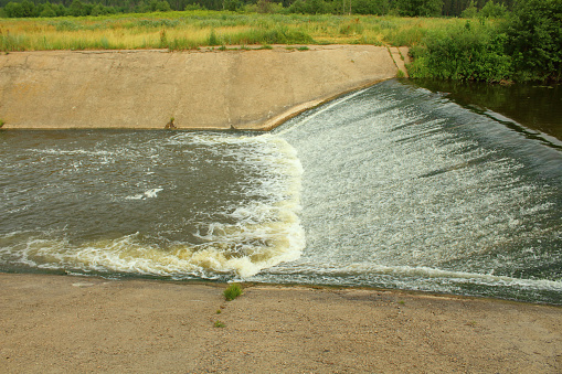 A small concrete dam on the river.