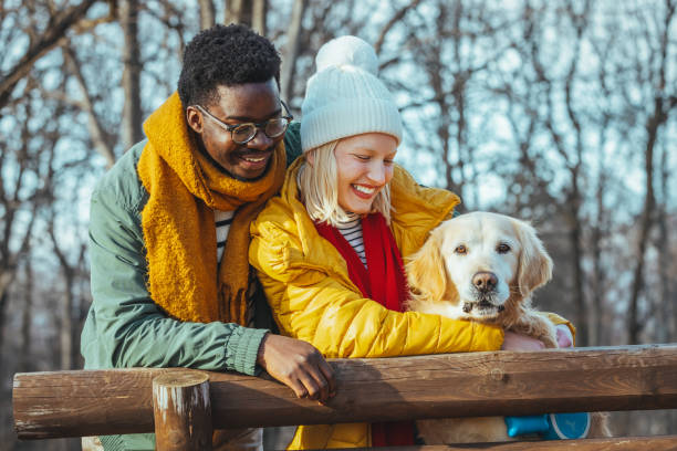 istock Couple with dog on a walk in an autumn forest. 1366950133