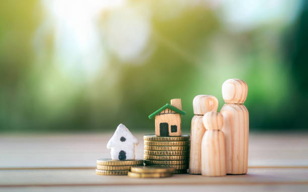 House placed on coins with happy wooden doll family placed on the table. planning savings money of coins to buy a home. House placed on coins with happy wooden doll family placed on the table. planning savings money of coins to buy a home, concept for property, mortgage and real estate investment. savings for a house. human representation photos stock pictures, royalty-free photos & images