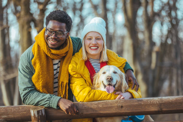 istock Couple with dog on a walk in an autumn forest. 1366950357