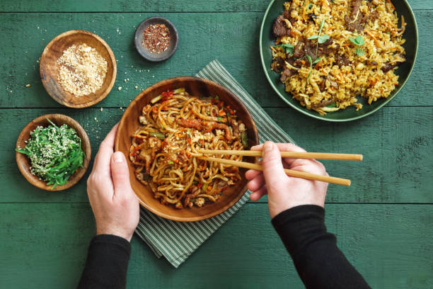 istock Man Eating Spicy Korean Beef Noodles 1366953055