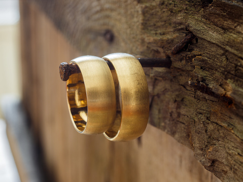 Wedding rings hanging on the old board