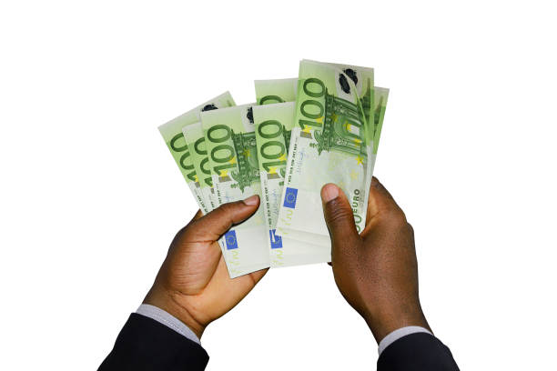 istock Black Hands in suit holding 3D rendered 100 Euro notes 1366954411