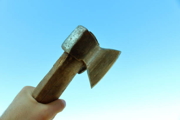 istock The old ax in the man's hand. Close-up. Background. Isolated. 1366954616