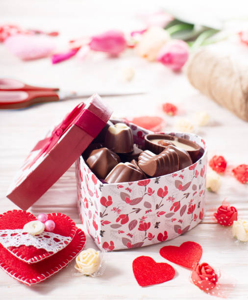 istock Chokolate box in shape of heart on white wooden table valentine background low angle view 1366954842