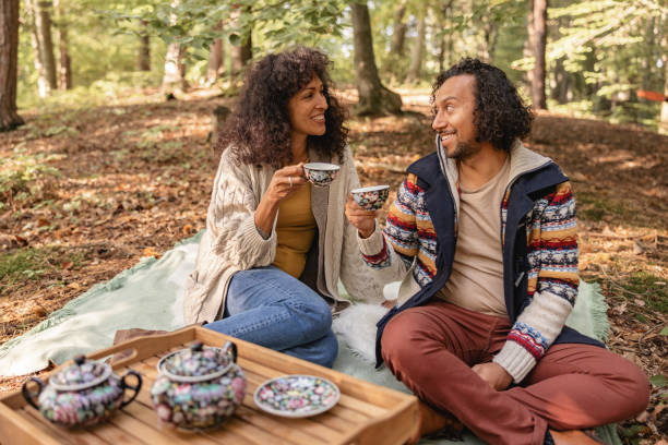 istock Hispanic Couple Having A Picnic In The Woods 1366955478