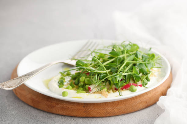 vegan healthy salad made of microgreen sprouts peas stock photo