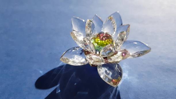 istock Beautiful crystal lotus flower on a blue sunny table 1366957387