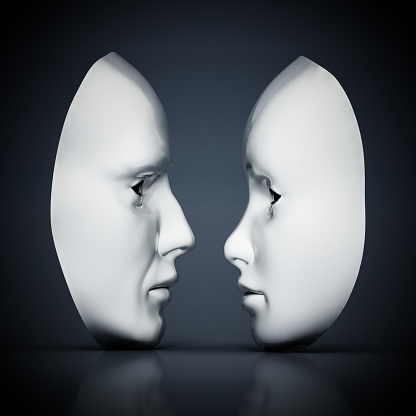 White male and female masks standing opposite to each other.
