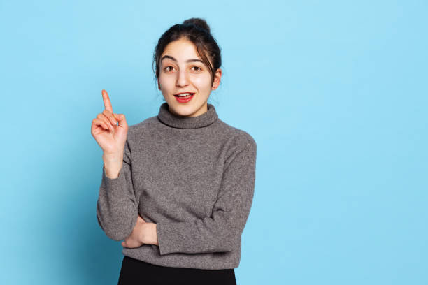 istock Surprised young beautiful girl wearing gray pullover isolated on blue background. Concept of emotions, facial expression, youth, aspiration, sales 1366957550