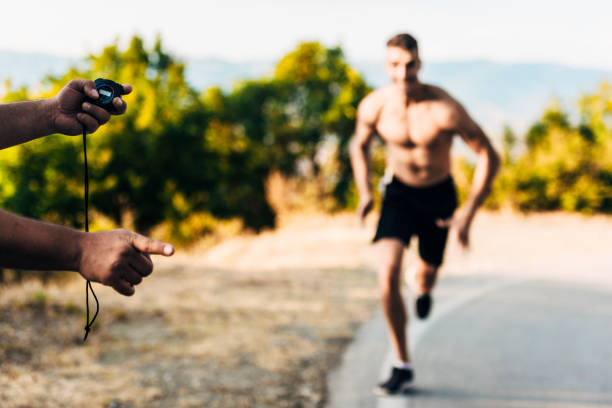 Man hand holding stop watch and measure time for runner