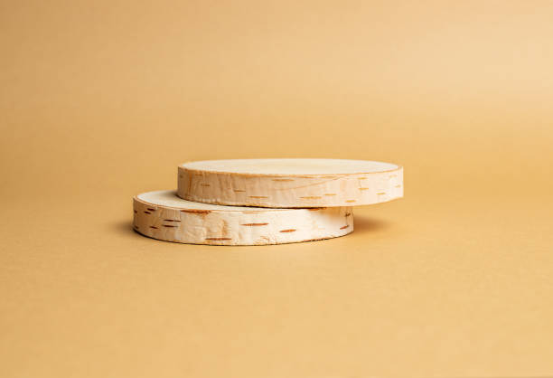 istock Two wooden discs stacked as a podium on beige background for product presentation. Copy space 1366960383