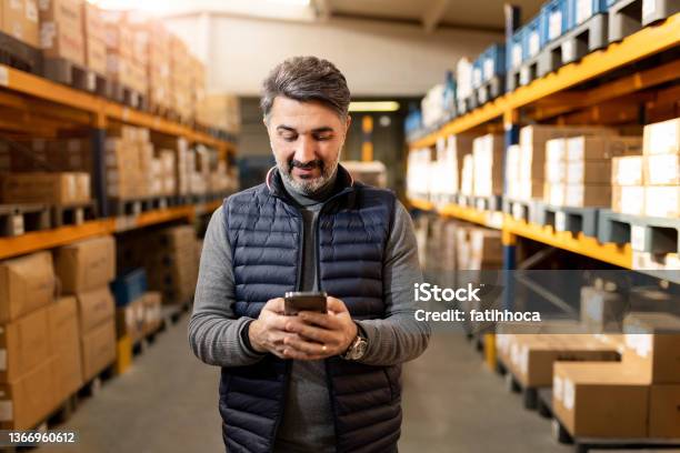 Adult Foreman In Warehouse Stock Photo - Download Image Now - Small Business, Business, Using Phone