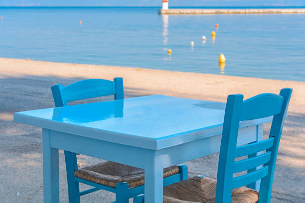 istock Blue table and chairs in a typical tavern in Greece with sea background 1366961070