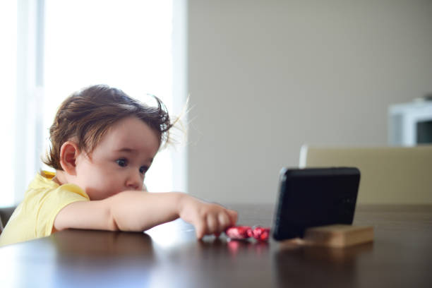 istock Girl kid watching video on smartphone. 1366962632