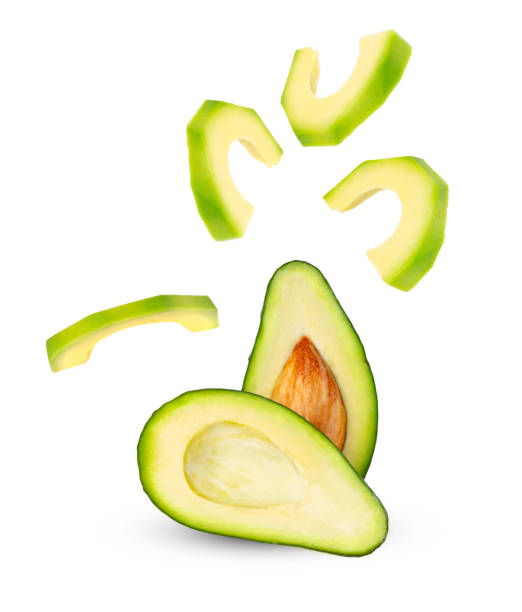 istock Levitation of avocado slices on a white background. Half an avocado. 1366963805