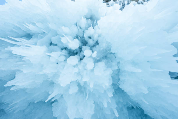 Ice cave with huge icicles on the Lake Baikal in winter. Siberia, Russia.