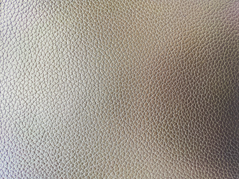 A light brown leather as a background or texture.