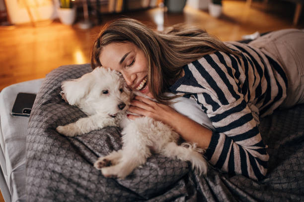 istock Woman playing with puppy 1366966120