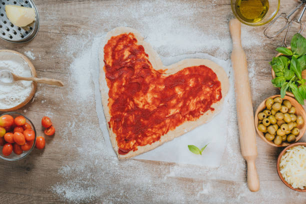 istock Heart shape homemade pizza on the table 1366967681