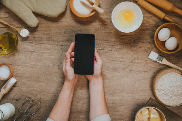 istock Female hands using smartphone with epmty screen near ingridients 1366967918