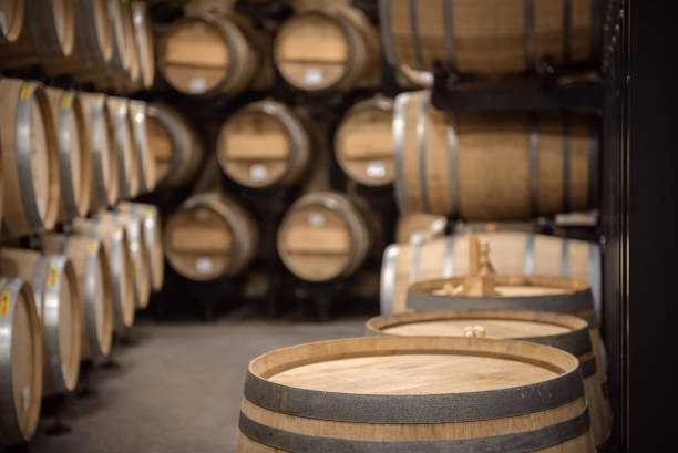istock Wooden barrel with copy space on top and winery vault interior on background 1366967969