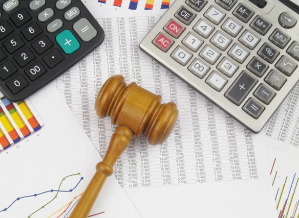 istock Arbitration concept, wooden judge gavel and calculators on financial documents. 1366968294