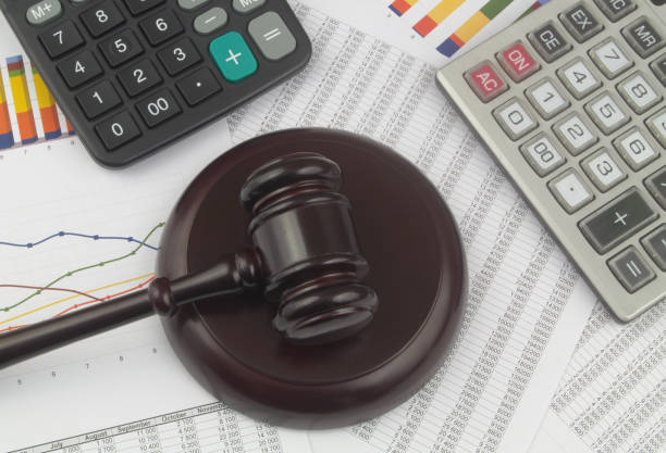 istock Arbitration concept, wooden judge gavel and calculators on financial documents. 1366968300