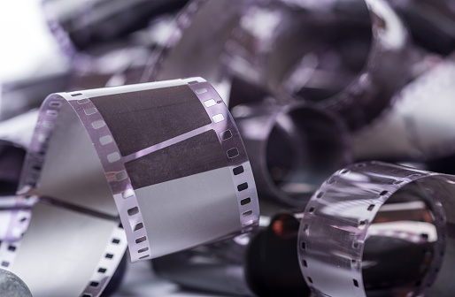 Film or photo negatives as rolls on a pile