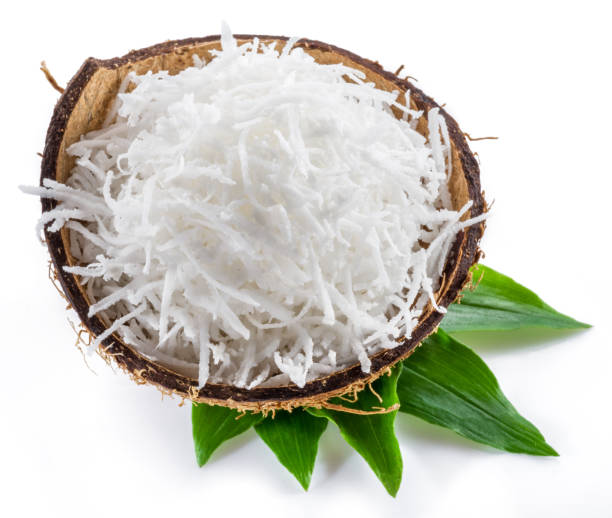 istock Shredded coconut flakes in the coconut shell isolated on white background. 1366969619