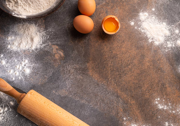 istock Preparation for dough cooking. Top view of board, rolling pin and flour. 1366969744