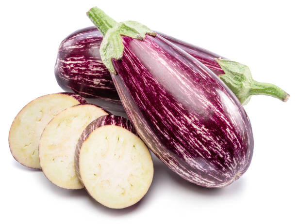 istock Fresh striped aubergines or eggplants with leaf and slices isolated on white background. 1366969833
