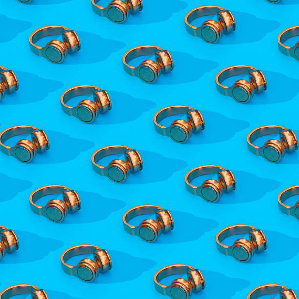 istock wireless headphones in gold color on a light blue background. 1366970830