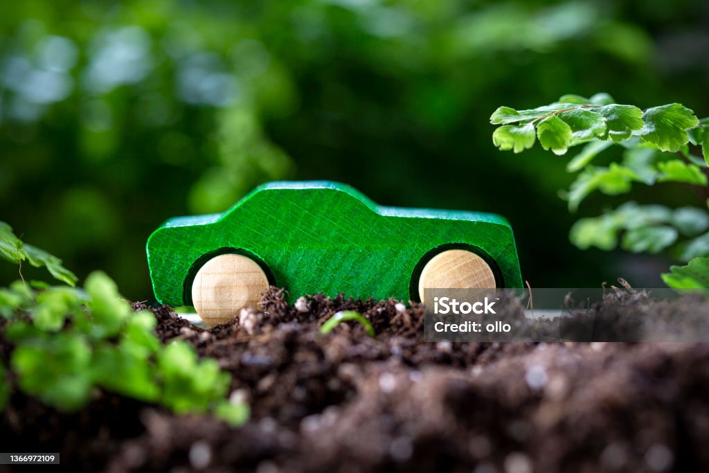 Wooden toy car in the nature - concept of sustainable mobility Greenwashing Stock Photo