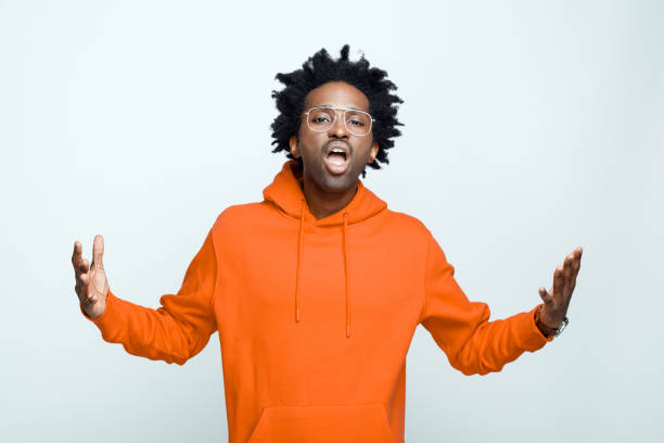 istock Portrait of man in orange hoodie 1366972717