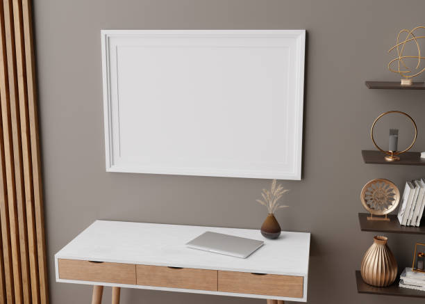 istock Empty picture frame on brown wall in modern home office. Mock up interior in scandinavian style. Free space, copy space for your picture, text, or another design. Desk, shelf with decor. 3D rendering. 1366972769