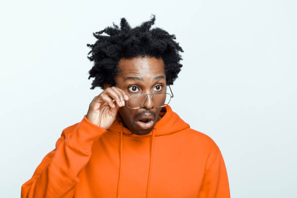 istock Shocked man in orange hoodie 1366974065