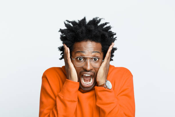 istock Terrified man in orange hoodie 1366975172