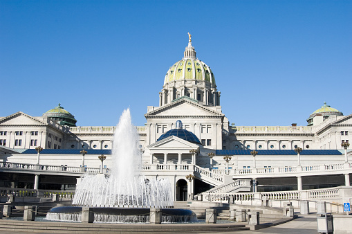 Pennsylvania state capitol government building in Harrisburg, rear view with water fountain and rotunda, USA.